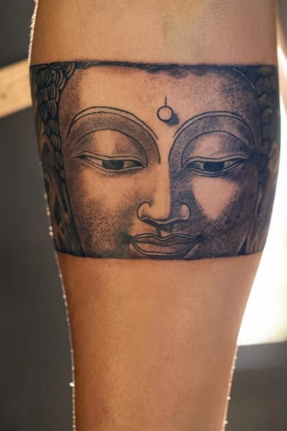 Dotwork Buddha armband wrapping the forearm