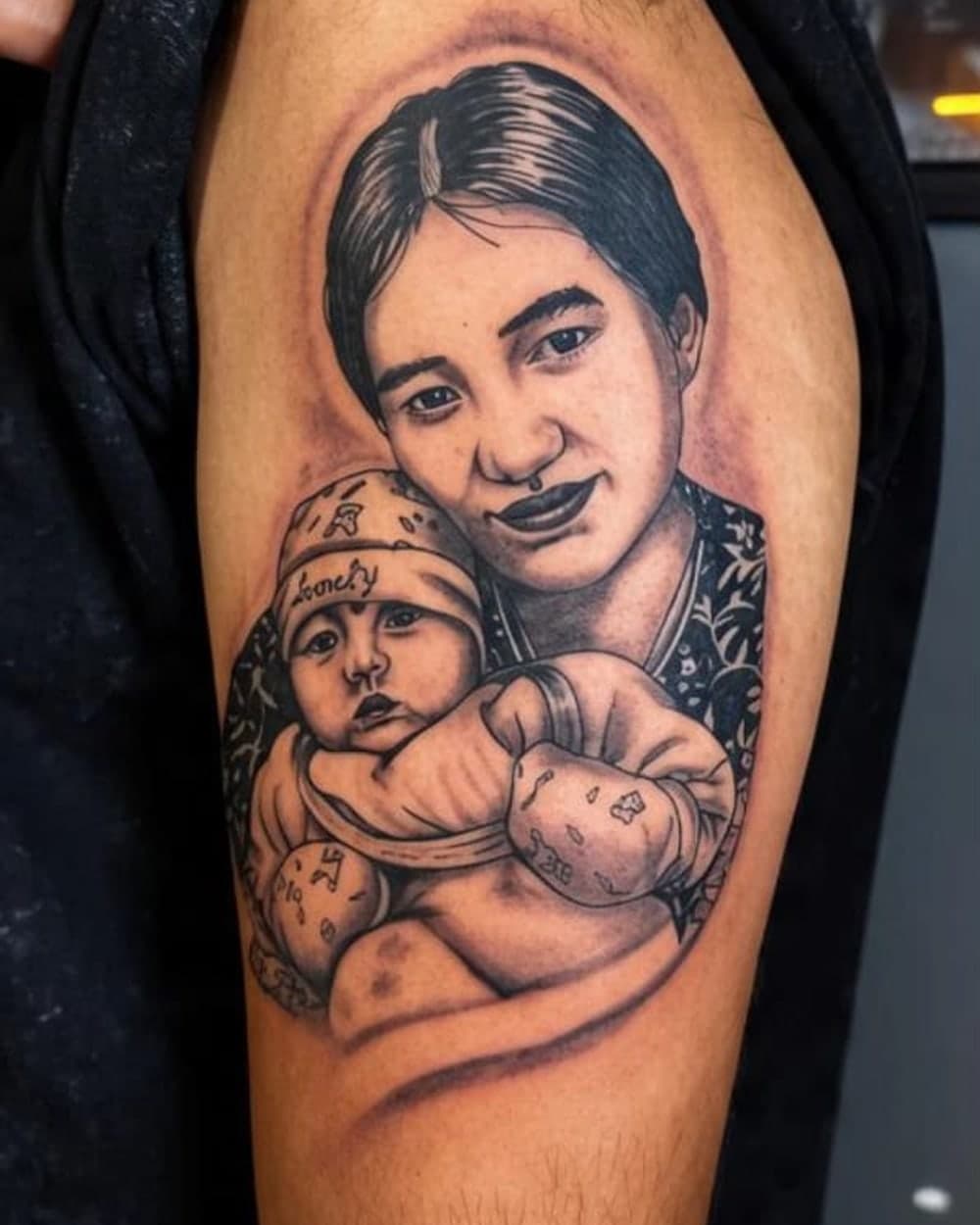 Photorealistic black and grey portrait tattoo on a forearm