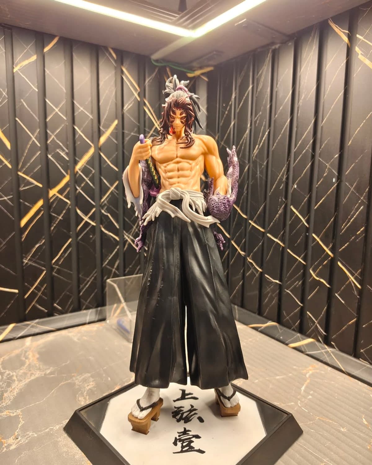 Demon Slayer collectible figure on a display stand